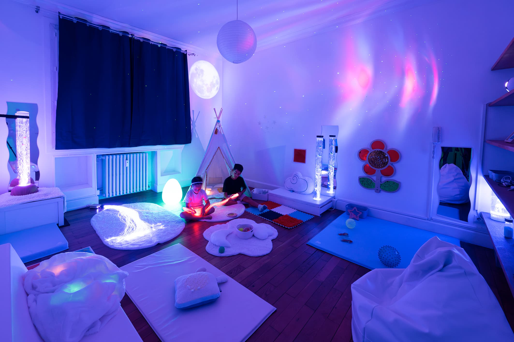 Salle Snoezelen avec ambiance tamisée et équipements sensoriels